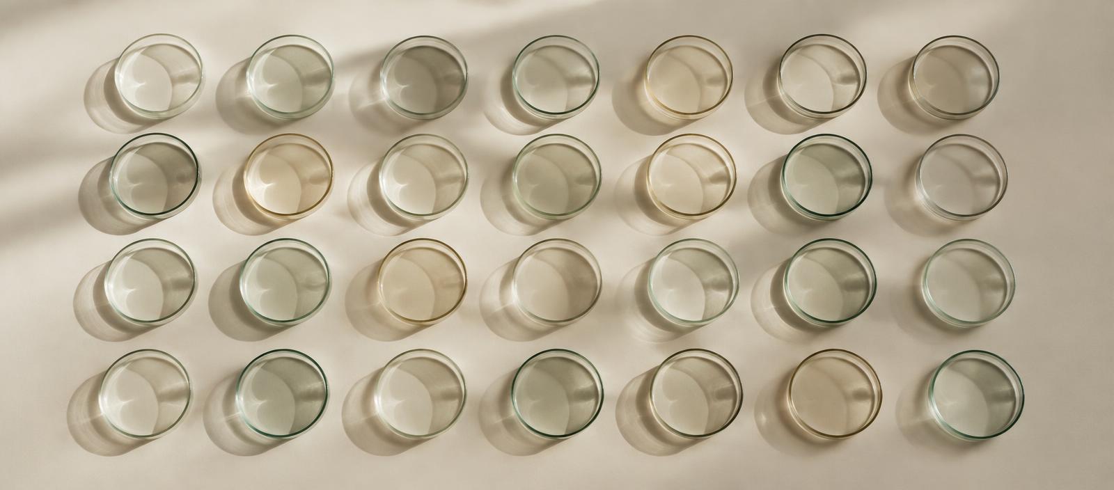 Clinical research documentation and laboratory glassware on a pale surface